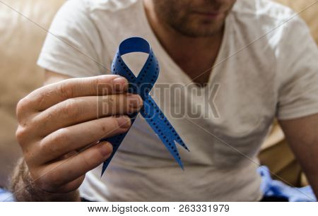 Man Holding A Blue Ribbon, Blue November Concept