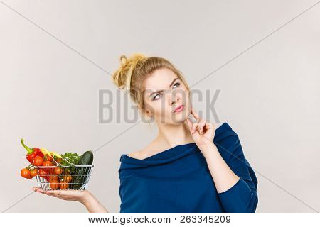 Adult Woman With Raw Food, Questioning Healthy Lifestyle Recommendations, Origin Vegetagles. Female 