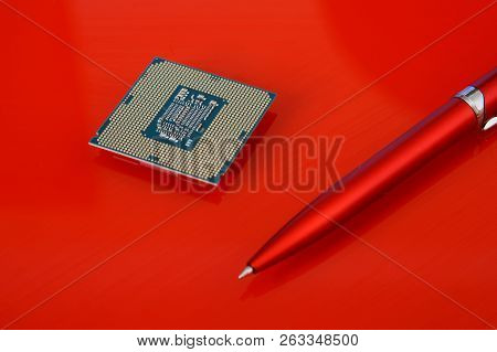 The Processor For Socket Lga 1151 Lies On A Red Background Next To The Pen. Computer Techologies.