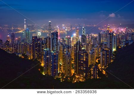 Famous view of Hong Kong - Hong Kong skyscrapers skyline cityscape view from Victoria Peak illuminated in the evening blue hour. Hong Kong, China