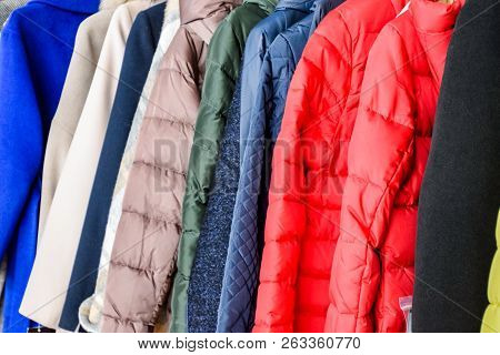 Coats And Jackets On Hangers In The Store. Sale Of Outerwear