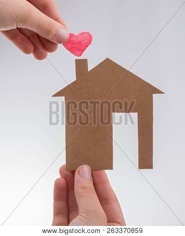 Hand Holding A Aper House On A Canvas Background