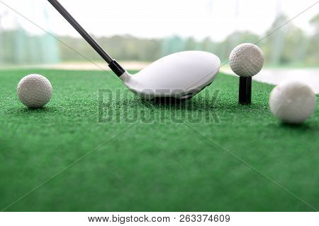 Golf Club And Balls On A Synthetic Grass Mat At A Practice Range.