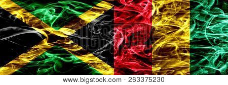 Jamaica Vs Guinea, Guinean Smoke Flags Placed Side By Side. Thick Colored Silky Smoke Flags Of Jamai