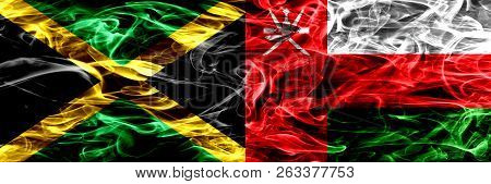 Jamaica Vs Oman, Omani Smoke Flags Placed Side By Side. Thick Colored Silky Smoke Flags Of Jamaican 