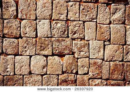 Tekstur af sten mur af gamle mayaernes pyramider i Uxmal i Mexico