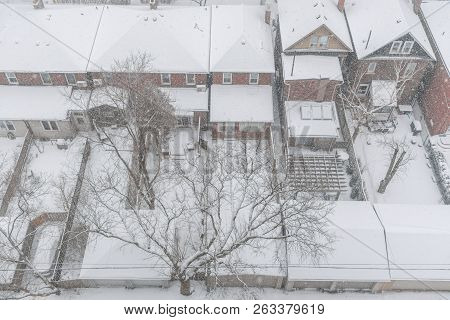 View From Above On Residential Houses And Roofs Covered With Snow During Winter Snow Storm In Toront