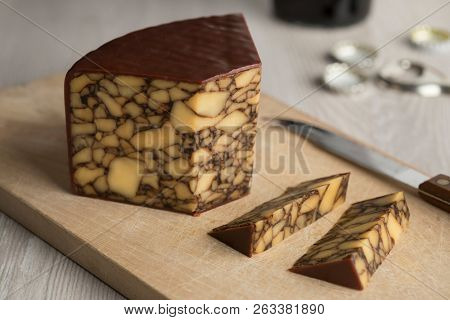 Piece of Irish Cahills porter cheese on a cutting board