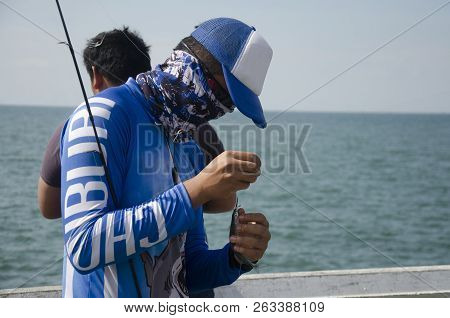 Thai Angler Or Fisherman Use Fishing-rod Fishing Fish In The Sea In Chonburi, Thailand