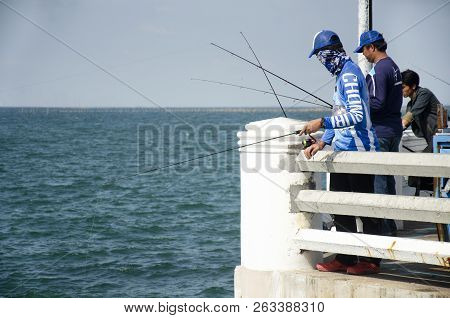 Thai Angler Or Fisherman Use Fishing-rod Fishing Fish In The Sea In Chonburi, Thailand