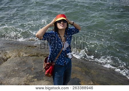 Thai Woman People Posing For Take Photo On The Rock In The Sea In Chonburi, Thailand
