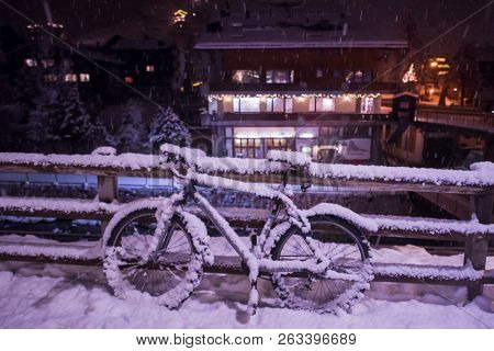 end of biking season.parked bicycle covered by snow from a heavy snowstorm.Winter cycling