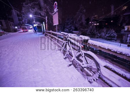 end of biking season.parked bicycle covered by snow from a heavy snowstorm.Winter cycling