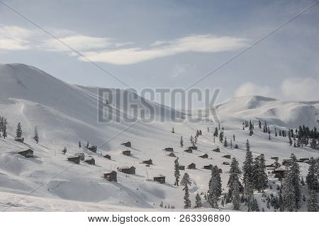 Gorgeous Winter Landscape Of Snow Covered Hills With Trees And Houses On The Popular Tourist Resort 