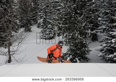 Man Walking With The Snowboard In The Mountain Up The Hill In The Popular Tourist Resort In Goderzi,