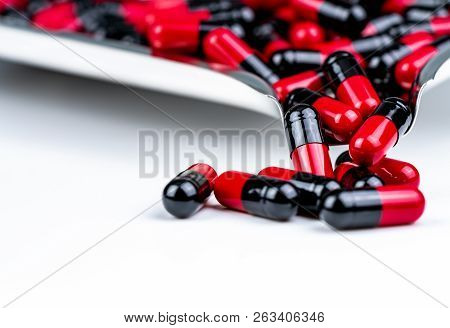Selective Focus Of Red And Black Capsule Pills On Stainless Steel Drug Tray. Antibiotics Drug Resist
