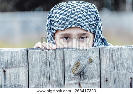 Crying Refugee Girl From The East In A Headscarf