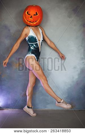 Sexy Woman With Carved Pumpkin On Her Head For Halloween