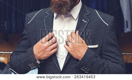 Man Posing In Black Suit. Handsome Brutal Bearded Man In Stylish Black Jacket, White Shirt Inside Of