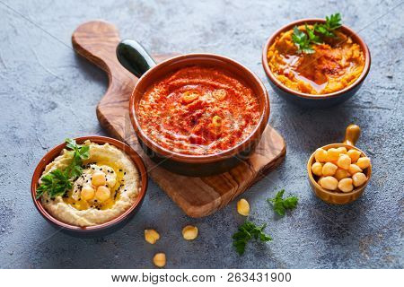  pumpkin hummus red pepper hummus and lentils hummus on wooden table