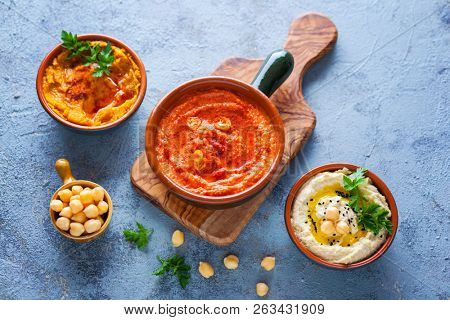  pumpkin hummus red pepper hummus and lentils hummus on wooden table
