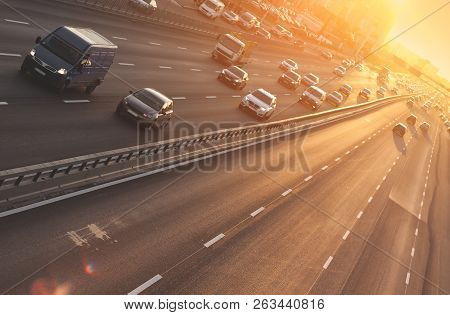 Cars On Highway. Sunset Cityscape. Contrejour Wallpaper