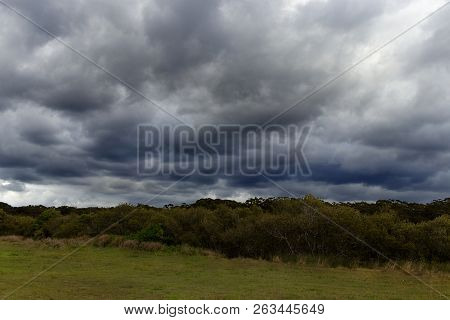 Dramatic Storm Clouds Rolling Over Grassy Fields