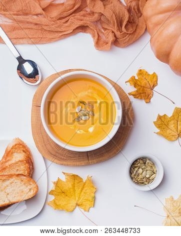 A Bowls Of Delecious Homemade Pumpkin Soup With Cream On The White Background