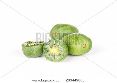 Group Of Two Whole Two Halves Of Fresh Green Mini Baby Kiwi Fruit Isolated On White Background
