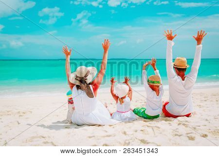 Happy Family With Kids Hands Up On Beach