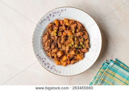 Turkish Traditional Tas Kebab With Potato, Pea And Tomato In A White Plate
