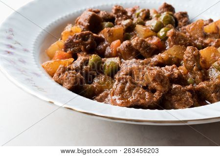 Turkish Traditional Tas Kebab With Potato, Pea And Tomato In A White Plate
