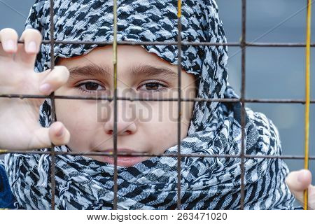 Crying Refugee Girl From The East In A Headscarf