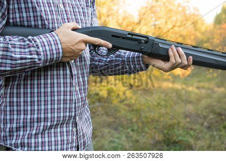 Male With Semi-automated Shotgun In The Autumn Forest Ready To Hunting, Close Up View