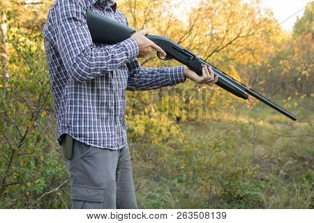 Male With Semi-automated Shotgun In The Autumn Forest Ready To Hunting, Close Up View