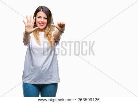 Young beautiful woman casual white t-shirt over isolated background showing and pointing up with fingers number six while smiling confident and happy.
