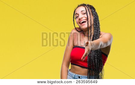 Young braided hair african american with pigmentation blemish birth mark over isolated background smiling friendly offering handshake as greeting and welcoming. Successful business.