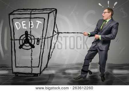 Debts Concept. Businessman Is Dragging Along The Road A Safe With Accumulated Debts. No Money To Pay