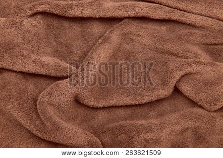 Background And Texture. The Blurred Image Of The Texture Of The Fabric For Clothing. Brown Fur. Crop