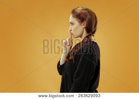Secret, Gossip Concept. Young Woman Whispering A Secret Behind Her Hand. Business Woman Isolated On 