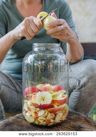 Woman Makes Apple Vinegar - Peeling Apple And Cut It Into A Bottle