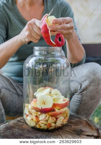 Woman Makes Apple Vinegar - Peeling Apple And Cut It Into A Bottle