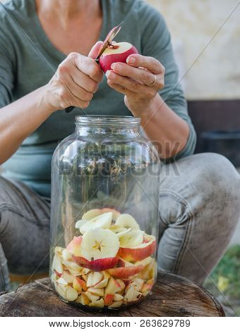 Woman Makes Apple Vinegar - Peeling Apple And Cut It Into A Bottle