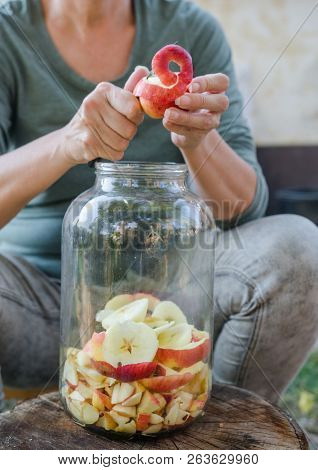 Woman Makes Apple Vinegar - Peeling Apple And Cut It Into A Bottle
