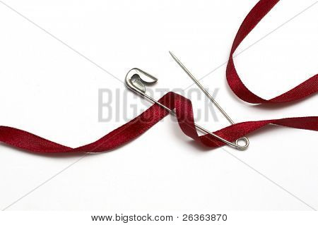safety pin and red ribbon