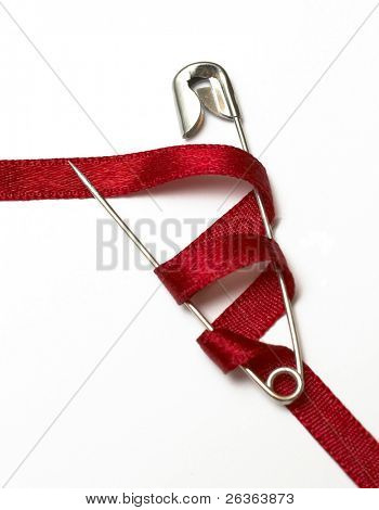 safety pin and red ribbon
