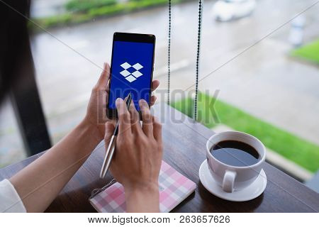 Chiang Mai, Thailand - August 18,2018: Woman Hands Holding Huawei With Dropbox On Screen. Dropbox Is