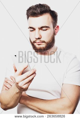 Tehnology and people concept: Bearded man  typing sms on white  background