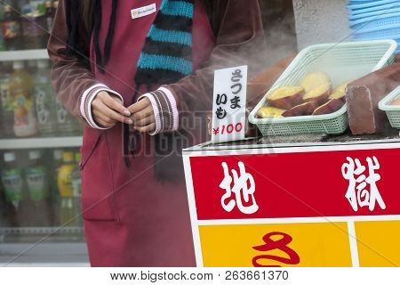 Beppu, Japan - December 29, 2009: Street Seller Selling Food On Outdoors Market. Close-up Image. Boi