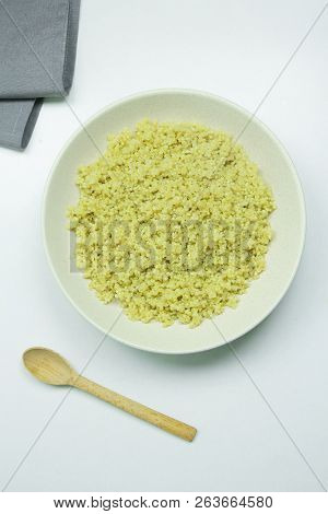 Cooked Quinoa In White Ceramic Bowl On White Background